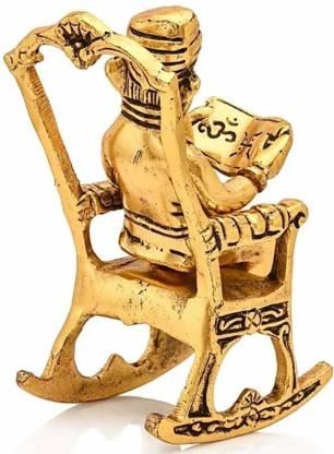 Golden Statue Sitting On A Rocking Chair