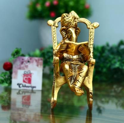 Golden Statue Sitting On A Rocking Chair
